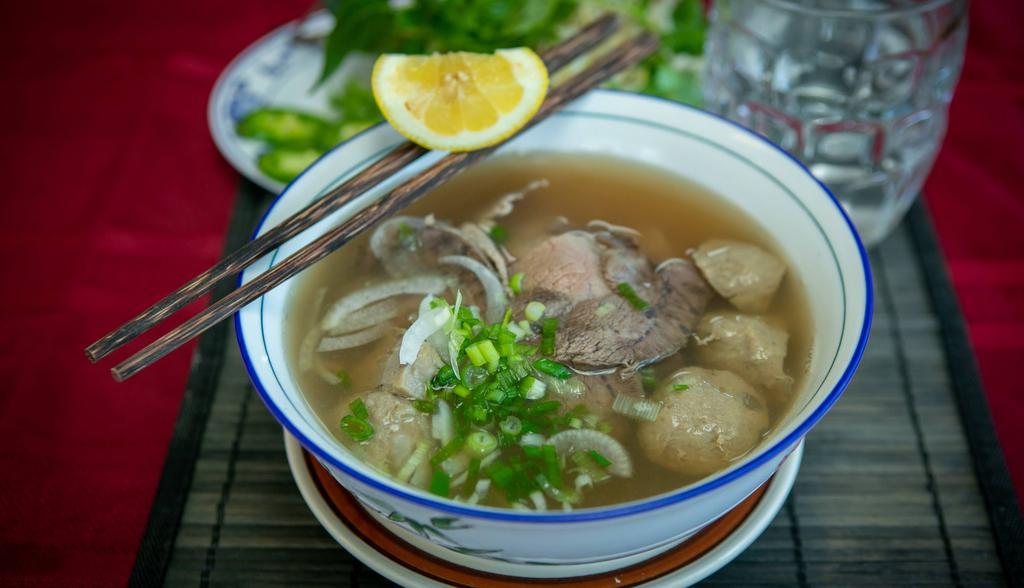 6. Combination Beef Noodle Soup · Thinly sliced beef, meatball, & well-done flank. White rice noodles with thinly sliced beef, beef meatballs, flank meat & beef broth topped with green onions and served with bean sprouts, cilantro, jalapeno, & lemon wedge.