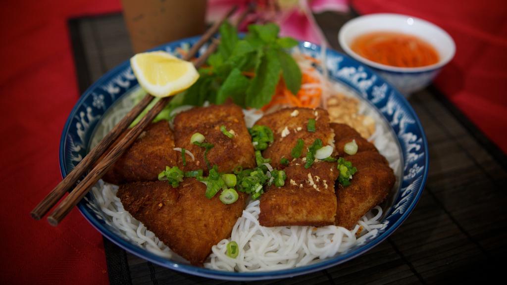 40. Lemongrass Fish · Fried tilapia fish seasoned with lemongrass served with white vermicelli noodles and vegetables. Topped with peanuts and onions.