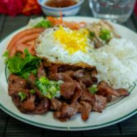 42. Grilled Pork, Shredded Pork, and Fried Egg · Grilled pork marinated with our Le Paradis house sauce, fried egg, shredded pork, served wit...