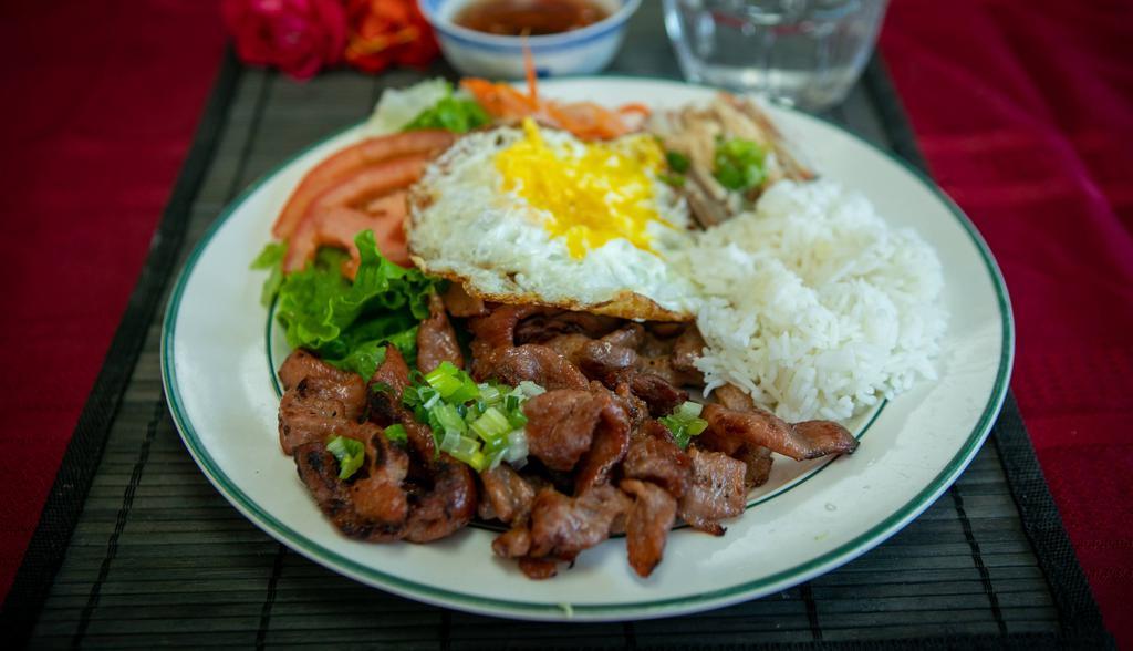 42. Grilled Pork, Shredded Pork, and Fried Egg · Grilled pork marinated with our Le Paradis house sauce, fried egg, shredded pork, served with rice and vegetables. Add extra beef/chicken, tomato fried rice, extra shrimp, garlic noodles, fried egg for an additional charge.