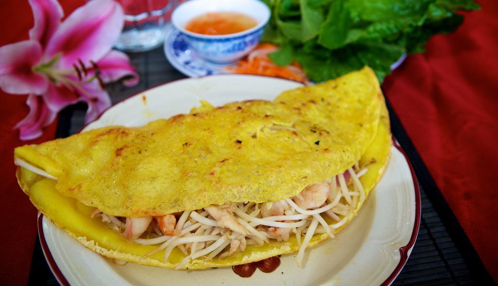 67b. Vietnamese Crepe · Crispy rice flour with bean sprouts, white onions, chicken, and shrimp, and served with lettuce, cucumber, and pickled carrots.