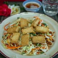 72. Fried Tofu Salad · Dish includes peanuts. Steamed tofu over cabbage, carrots, herbs, vinaigrette carrots, tosse...