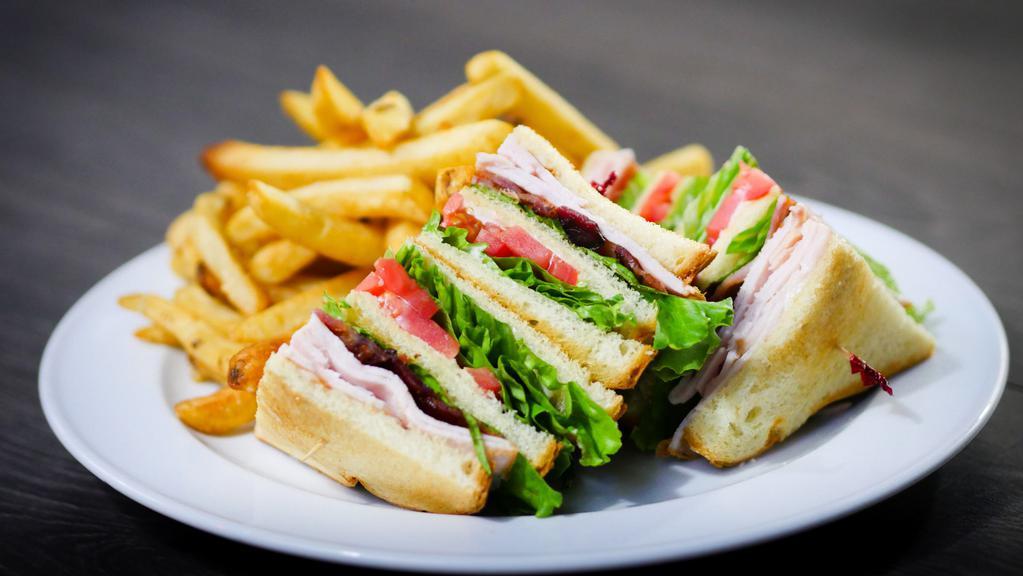 Turkey Club · Served with french fries.  Fresh roasted turkey, applewood smoked bacon, tomato, lettuce, mayonnaise, toasted white bread.