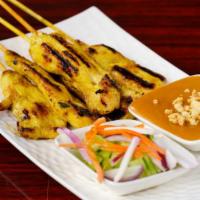 Chicken Sa Tae · Grilled chicken skewers five pieces marinated in herbs, spices, and yellow curry. Served wit...