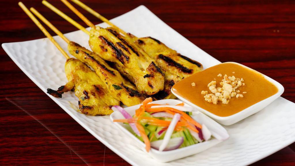 Chicken Sa Tae · Grilled chicken skewers five pieces marinated in herbs, spices, and yellow curry. Served with peanut sauce and cucumber salad
