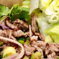 Num Tok · Roasted pork or beef with mint, red onions, scallions, cilantro, and ground roasted rice in ...