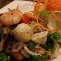 Yum Pla Muk (Squid Salad) · Spicy. Squid salad mixed with onions, chili, ginger, basil, and lemongrass in red chili-lime...