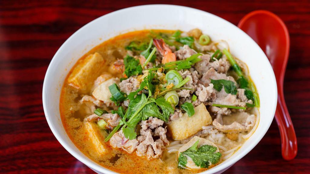 Tom Yum Noodle Soup · Hot and spicy noodle soup served with ground pork, sliced pork, pork balls, shrimp, fish cake, and ground peanuts.