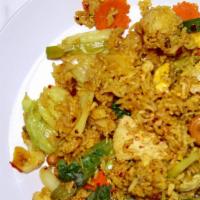 Pineapple Fried Rice · Fried rice with pineapple, eggs, raisin, cashew nuts, onions, carrots and choice of pork, be...