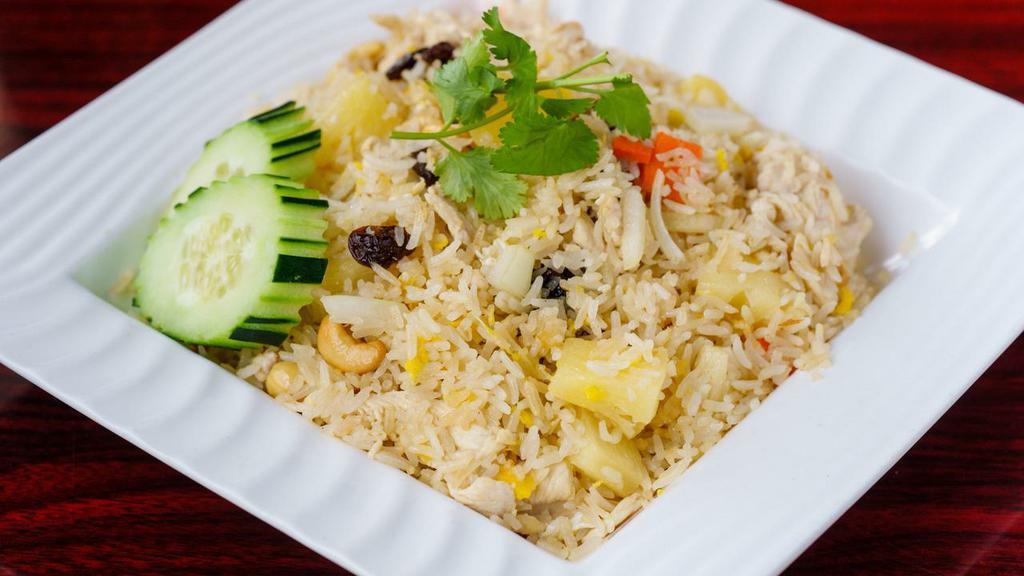Vegetarian Pineapple Fried Rice · Fried rice with pineapple, eggs, raisin, cashew nuts, onions, and carrots.