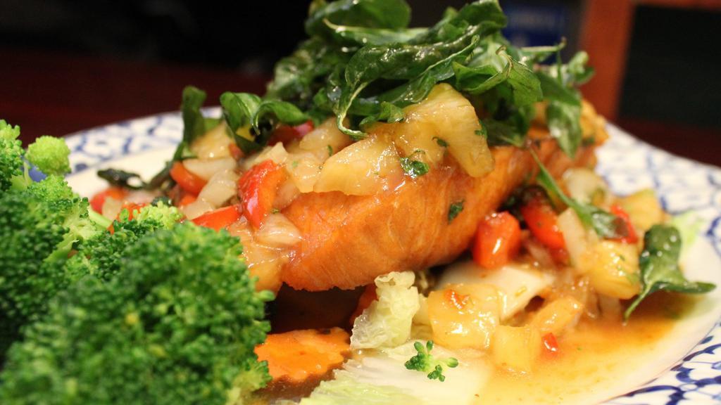 Pla Sarm Ross · Fried Atlantic salmon fillet with pineapple and onions topped with sweet chili sauce and fried thai holy basil.