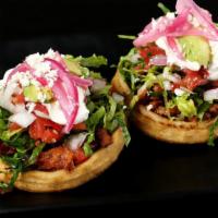 Sopes · Your choice of protein on top of thick fried masa with lettuce, pickled red onion, salsa, ch...