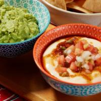 Queso Dip · Monterey jack cheese, house pico, & chili oil. Served with house chips.

vegetarian