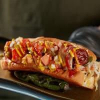 The MVP Sonora Dog · Applewood Bacon-wrapped hot dog on griddled bun. griddled onions & peppers, house curtido, h...