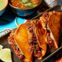 Quesabirrias   · Dipped and Griddled Corn Tortilla stuffed with cheese, onions, cilantro, original braised be...