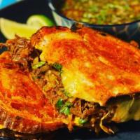Birria Grilled Cheese · Artisan Achiote Garlic Sourdough with prime beef birria, American & jack cheese. Served with...