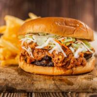 The Birria Burger · 8 oz Fresh angus chuck patty with slow cooked barbacoa, shredded cheese, onion, cilantro, an...