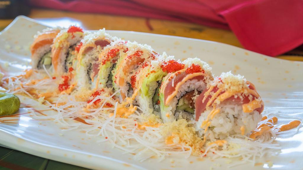 R7-crunchy Rainbow Roll · Inside: spicy tuna, cucumber. outside: fresh salmon, tuna, avocado, masago with spicy mayo, unagi sauce and tempura crunch.