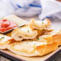 Cheesy Garlic Toast · Toasted bread garnished with garlic and butter. Topped with house blend cheese. Served with ...