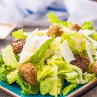 Caesar Salad · romaine lettuce, croutons ,shaved parmesan cheese with  Caesar dressing.