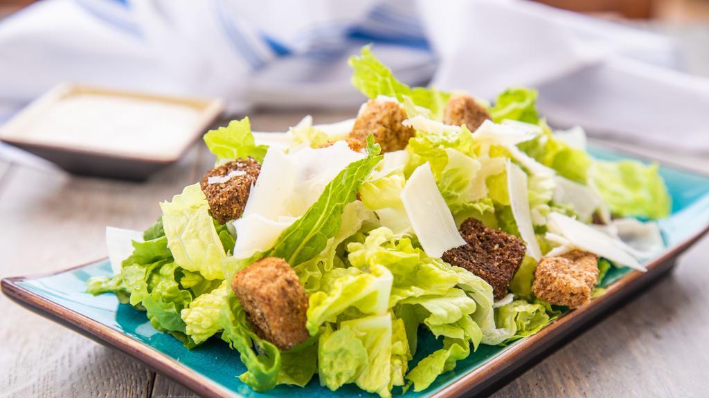 Caesar Salad · romaine lettuce, croutons ,shaved parmesan cheese with  Caesar dressing.