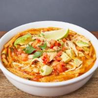SOPA DE TORTILLA · Home-made chicken soup with tomatoes, onions, jack cheese, avocado, tortillas, & lime