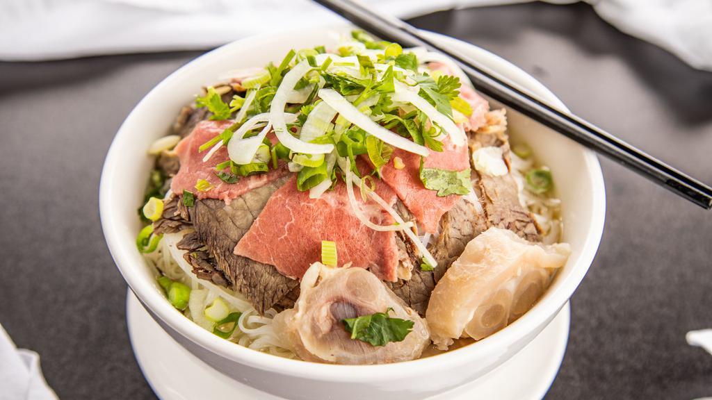 Combination Noodle Soup · Rice noodles with rare sliced eye round steak, well-done briskets and flanks, tendon and meatballs.