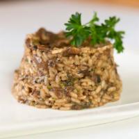 Risotto Ai Funghi · Italian Carnaroli rice sauteed with porcini mushroom blend and herbs. Topped with parmesan c...
