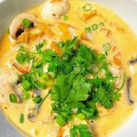 Tom Kha Soup · Hot and sour coconut milk soup with lemon grass, lime leaves, mushrooms, tofu, galangal and ...