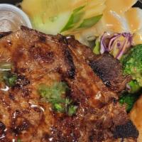 Grilled Pork Chop Over Rice · Comes with Egg Roll and side salad.