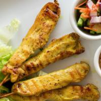 Satay Chicken · Marinated grilled chicken served with peanut sauce and cucumber salad.
