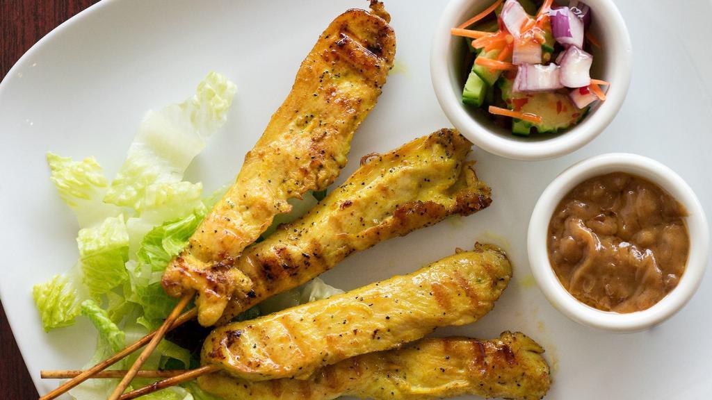 Satay Chicken · Marinated grilled chicken served with peanut sauce and cucumber salad.