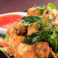 Winging · Fried chicken wing topped with crispy Thai basil and sweet chili sauce.