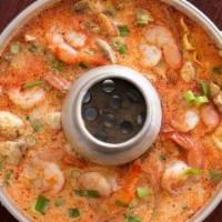 Tom Kha · Coconut milk soup with fresh mushrooms, onion, tomatoes, lemongrass, cilantro, and lime leav...