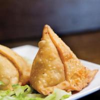 Veg-Samosa (2 Pieces) · Potato and green peas stuffed pastry, served with onion, tamarind and mint sauce.