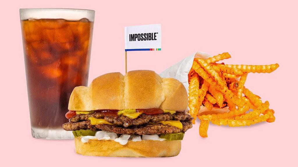 Impossible™ Beast Style Combo · Smashed crispy Impossible™ patties with house seasoning, American cheese, pickles, diced white onion, mayo, ketchup, and brown mustard on a soft roll served with your choice of seasoned or Beast style fries and a drink.