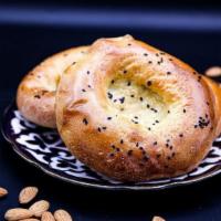 Kulcha Non PCS · Bread. Fluffy flatbread baked with white and black sesame seeds (flour, milk, and butter).