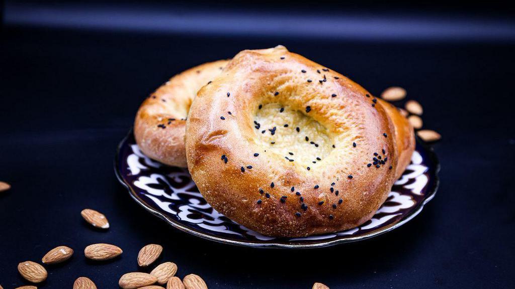 Kulcha Non PCS · Bread. Fluffy flatbread baked with white and black sesame seeds (flour, milk, and butter).