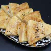Patir Kulcha PCS · Layered crust bread baked with butter, flour, and sesame seeds.