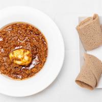 Minchet Wot · Ground Beef Stew cooked in a special blend of spices, onions  topped with one boiled egg