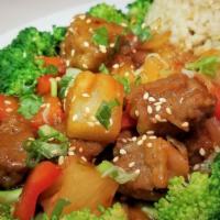 Happiness Over Rice · Pineapple, red pepper, onion, vegan chunk, broccoli, house special sweet and sour sauce serv...