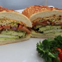 18. Grilled Chicken Pesto · Cajun mayo, Yellow mustard, lettuce, tomato, red onion, and pickles.
