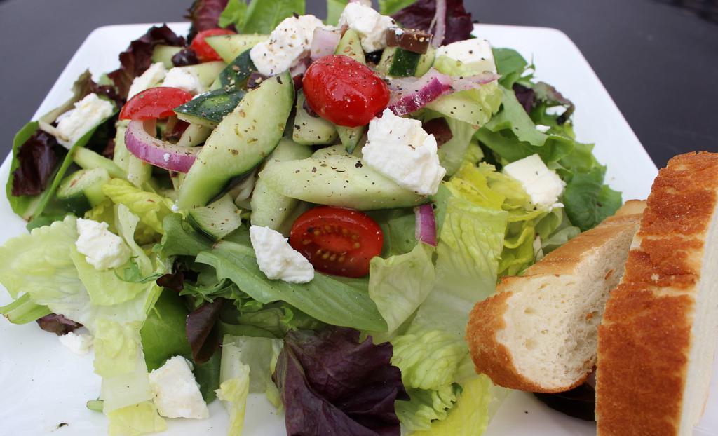 Greek Salad · Romaine lettuce, cherry tomatoes, red onions, cucumbers, Kalamata olives and feta cheese.