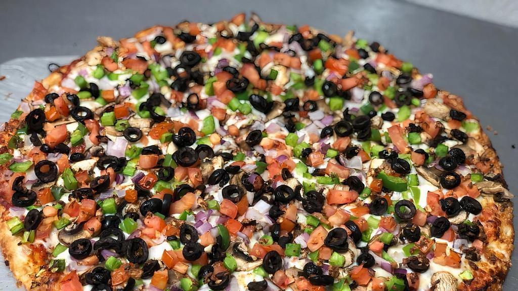 Veggie Supreme Pizza · Tomato sauce, mozzarella, mushrooms, tomatoes, red onions, olives, green peppers and garlic.