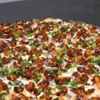 Tandoori Chicken Pizza · Garlic white sauce, mozzarella, tandoori chicken, red onions, bell peppers and cilantro.