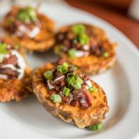 Loaded Potato Skins · With cheddar cheese, sour cream, green onion and bacon.