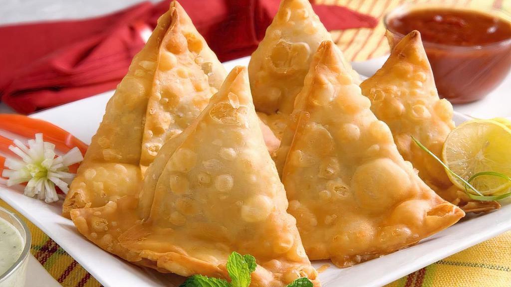 Vegetable Samosa (2) · Vegan. Crispy puffs filled with potatoes and green peas.