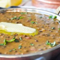 Dal Makhani · Black lentils, kidney beans cooked in a buttery sauce with onions and Indian spices.