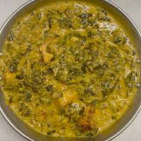 Palak Paneer · Tender spinach and cubed farmer's cheese cooked with spices.