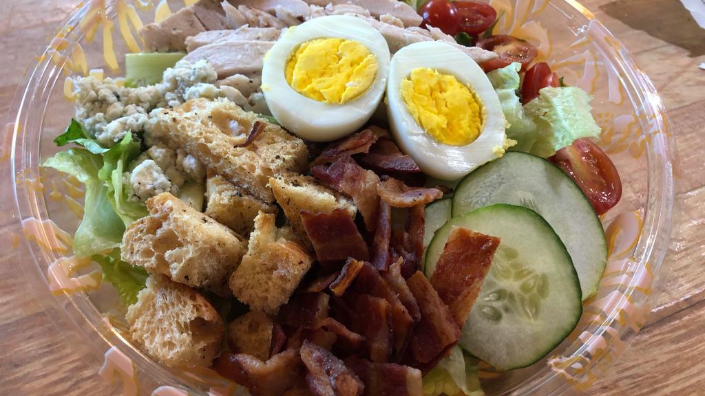 Artisan Chopped Salad · Romaine, roasted chicken, maple bacon, cherry tomato, cucumbers, sliced egg, blue cheese crumbles and diced red onion.